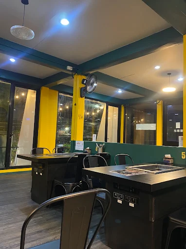 Flame House interior — grill tables